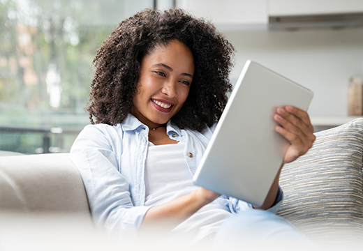 woman reading tablet on couch