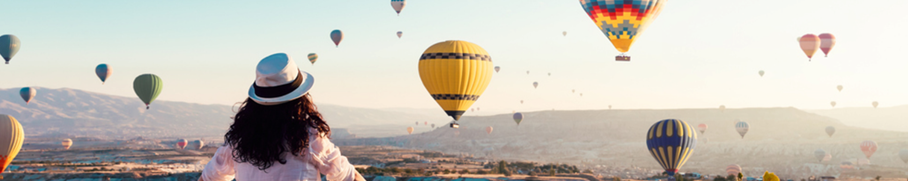 Woman looking at hot air balloons